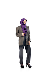 Image showing Beautiful arab woman posing in stylish office attire isolated on studio background. Fashion concept