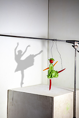 Image showing Flying food composition making beautiful ballerina drawing shadow on the wall