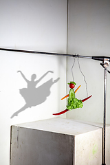 Image showing Flying food composition making beautiful ballerina drawing shadow on the wall