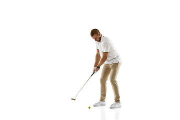 Image showing Golf player in a white shirt taking a swing isolated on white studio background