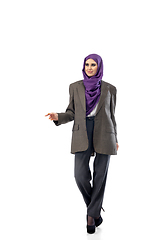 Image showing Beautiful arab woman posing in stylish office attire isolated on studio background. Fashion concept