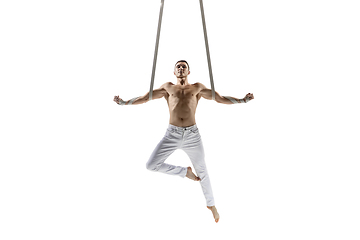 Image showing Young male acrobat, circus athlete isolated on white studio background. Training perfect balanced in flight