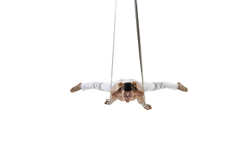 Image showing Young male acrobat, circus athlete isolated on white studio background. Training perfect balanced in flight