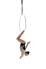 Image showing Young female acrobat, circus athlete isolated on white studio background. Training perfect balanced in flight