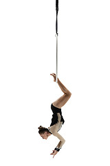 Image showing Young female acrobat, circus athlete isolated on white studio background. Training perfect balanced in flight