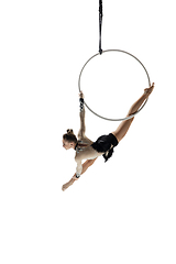 Image showing Young female acrobat, circus athlete isolated on white studio background. Training perfect balanced in flight