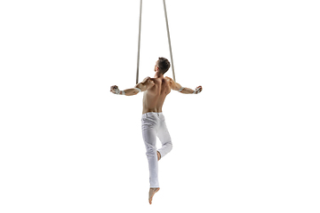 Image showing Young male acrobat, circus athlete isolated on white studio background. Training perfect balanced in flight