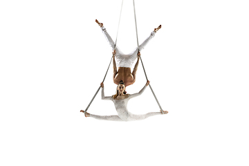 Image showing Couple of young acrobats, circus athletes isolated on white studio background. Training perfect balanced in flight