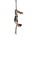 Image showing Young female acrobat, circus athlete isolated on white studio background. Training perfect balanced in flight