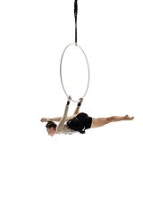 Image showing Young female acrobat, circus athlete isolated on white studio background. Training perfect balanced in flight