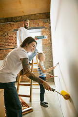 Image showing Young family doing apartment repair together themselves. Mother, father and son doing home makeover or renovation