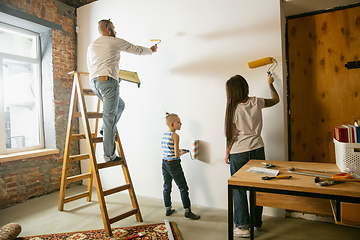 Image showing Young family doing apartment repair together themselves. Mother, father and son doing home makeover or renovation