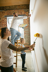 Image showing Young family doing apartment repair together themselves. Mother, father and son doing home makeover or renovation