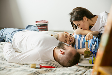 Image showing Young family doing apartment repair together themselves. Mother, father and son doing home makeover or renovation