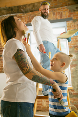 Image showing Young family doing apartment repair together themselves. Mother, father and son doing home makeover or renovation