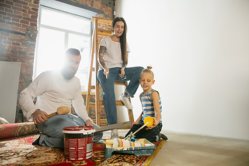 Image showing Young family doing apartment repair together themselves. Mother, father and son doing home makeover or renovation