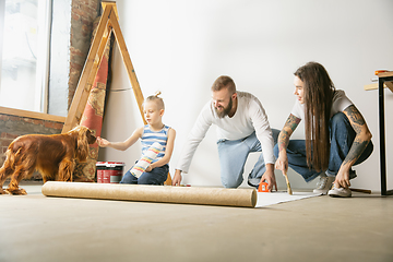 Image showing Young family doing apartment repair together themselves. Mother, father and son doing home makeover or renovation