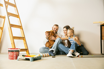 Image showing Young family doing apartment repair together themselves. Mother, father and son doing home makeover or renovation