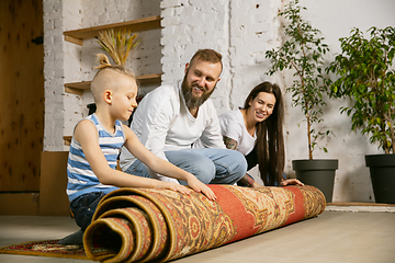 Image showing Young family doing apartment repair together themselves. Mother, father and son doing home makeover or renovation