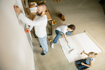 Image showing Young family doing apartment repair together themselves. Mother, father and son doing home makeover or renovation