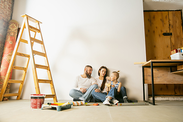 Image showing Young family doing apartment repair together themselves. Mother, father and son doing home makeover or renovation