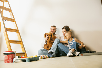 Image showing Young family doing apartment repair together themselves. Mother, father and son doing home makeover or renovation