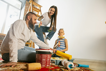 Image showing Young family doing apartment repair together themselves. Mother, father and son doing home makeover or renovation