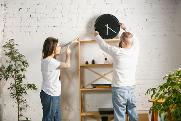 Image showing Young family doing apartment repair together themselves. Married man and woman doing home makeover or renovation