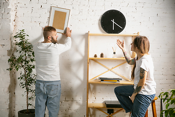 Image showing Young family doing apartment repair together themselves. Married man and woman doing home makeover or renovation