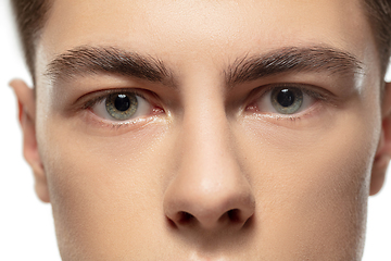 Image showing Close up face of young man isolated on white studio background. Caucasian attractive male model. Concept of fashion and beauty, self-care, body and skin care.