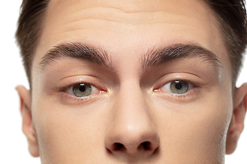 Image showing Close up face of young man isolated on white studio background. Caucasian attractive male model. Concept of fashion and beauty, self-care, body and skin care.