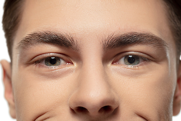 Image showing Close up face of young man isolated on white studio background. Caucasian attractive male model. Concept of fashion and beauty, self-care, body and skin care.