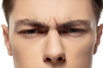 Image showing Close up face of young man isolated on white studio background. Caucasian attractive male model. Concept of fashion and beauty, self-care, body and skin care.