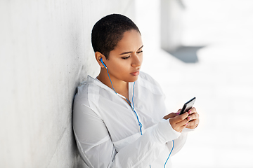 Image showing african american woman with earphones and phone