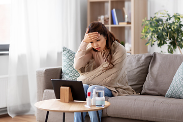 Image showing sick woman having video call on tablet pc at home