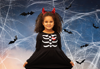 Image showing girl in black dress and devil's horns on halloween