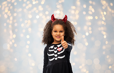 Image showing girl in black dress and devil's horns on halloween