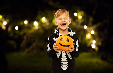 Image showing happy boy in halloween costume with jack-o-lantern