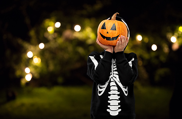 Image showing boy in halloween costume with jack-o-lantern