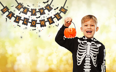 Image showing happy boy in halloween costume with jack-o-lantern