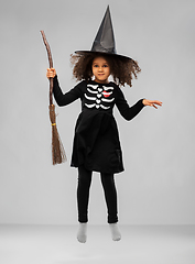 Image showing girl in black witch hat with broom on halloween