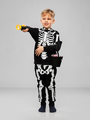 Image showing boy with candies and flashlight on halloween