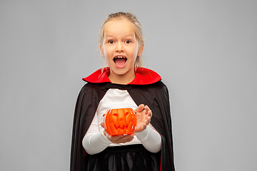 Image showing girl in halloween costume of dracula with pumpkin