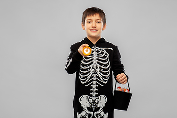 Image showing boy in halloween costume with candies and torch