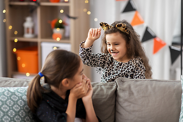 Image showing girls in halloween costumes playing with spider