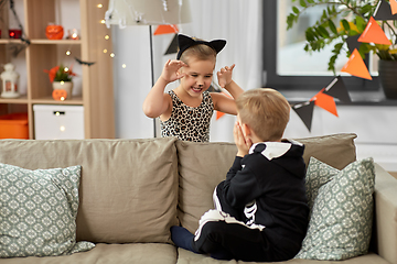 Image showing kids in halloween costumes playing at home