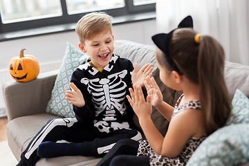 Image showing kids in halloween costumes playing game at home