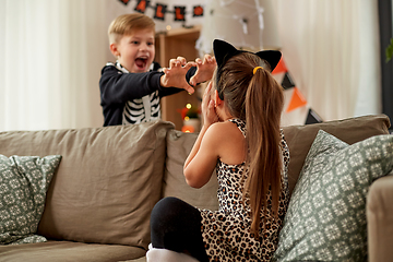 Image showing kids in halloween costumes having fun at home