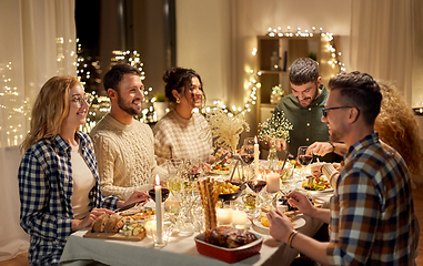 Image showing happy friends having christmas dinner at home