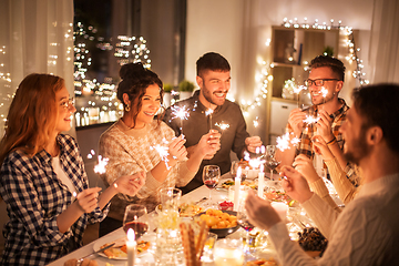 Image showing happy friends having christmas dinner at home